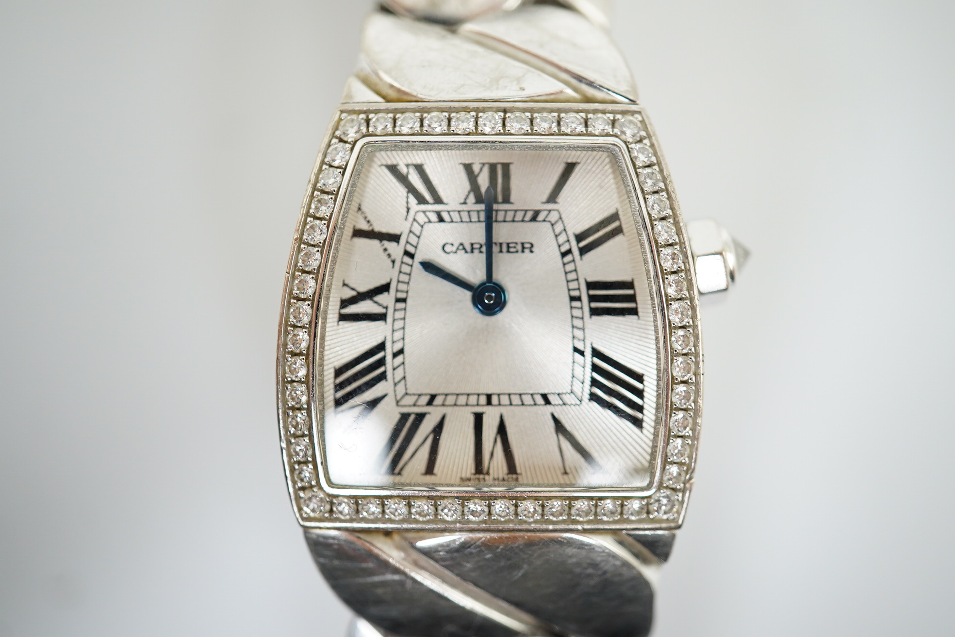 A lady's recent 18ct white gold and diamond set Cartier La Dona quartz wrist watch, on an 18ct white gold Cartier bracelet